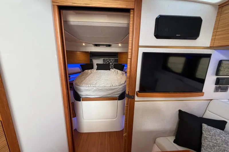  Yacht Photos Pics Interior of 2022 Boston Whaler 405 Conquest, featuring a cozy cabin with bed and TV.