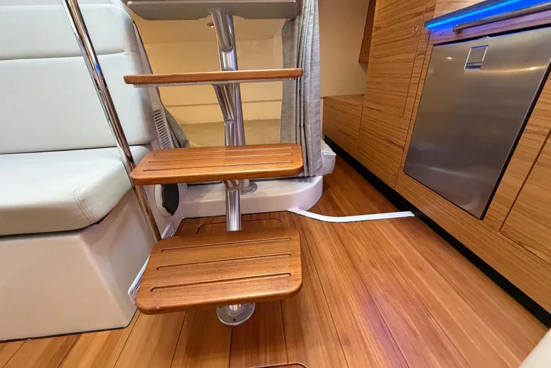  Yacht Photos Pics Interior of 2022 Boston Whaler 405 Conquest with wooden steps and modern cabinetry.