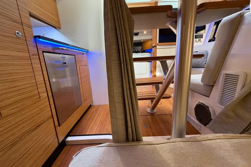  Yacht Photos Pics Interior of 2022 Boston Whaler 405 Conquest, featuring modern wood finishes and stainless steel appliances.