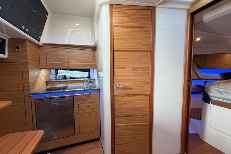  Yacht Photos Pics Interior of 2022 Boston Whaler 405 Conquest, featuring modern kitchen and cozy cabin space.