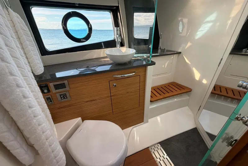  Yacht Photos Pics Luxurious bathroom interior of 2022 Boston Whaler 405 Conquest yacht with ocean view.