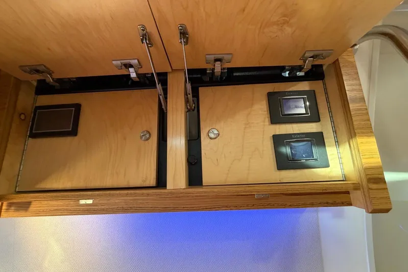  Yacht Photos Pics Interior view of 2022 Boston Whaler 405 Conquest, featuring wooden cabinetry and control panels.