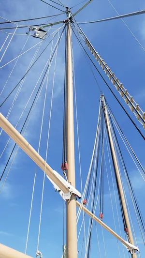 Daniel Webster Clements Yacht Photos Pics Alt text: 1996 Custom Biloxi Schooner masts and rigging against blue sky.