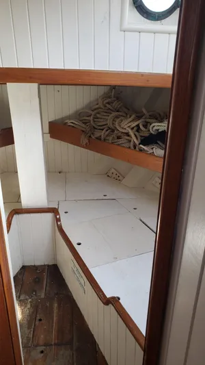 Daniel Webster Clements Yacht Photos Pics Interior of 1996 Custom Biloxi Schooner with wooden shelves and coiled ropes.