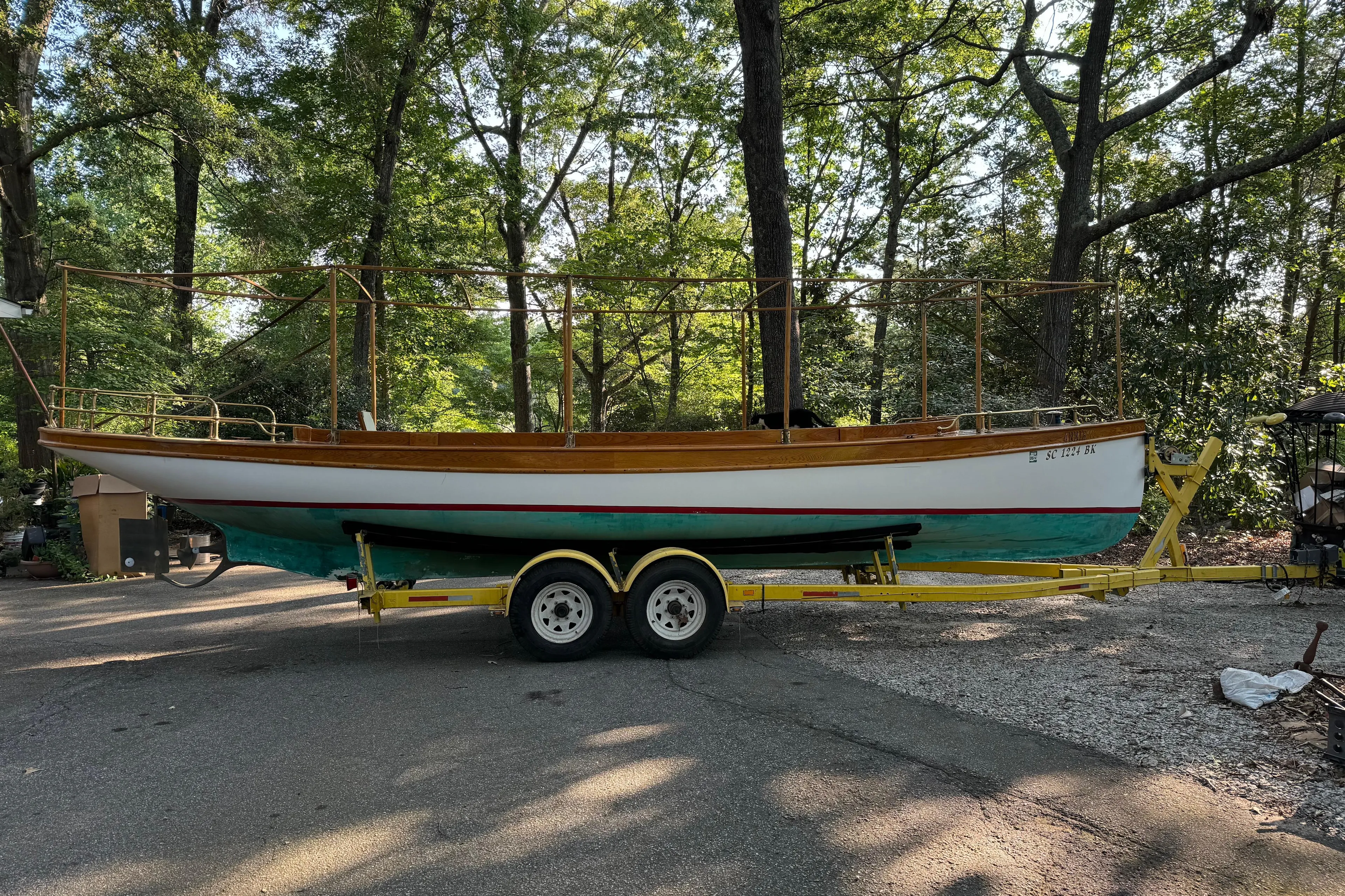 Annie Yacht Photos Pics 1989 Elco 30 Fantail Electric Launch on trailer, surrounded by trees.