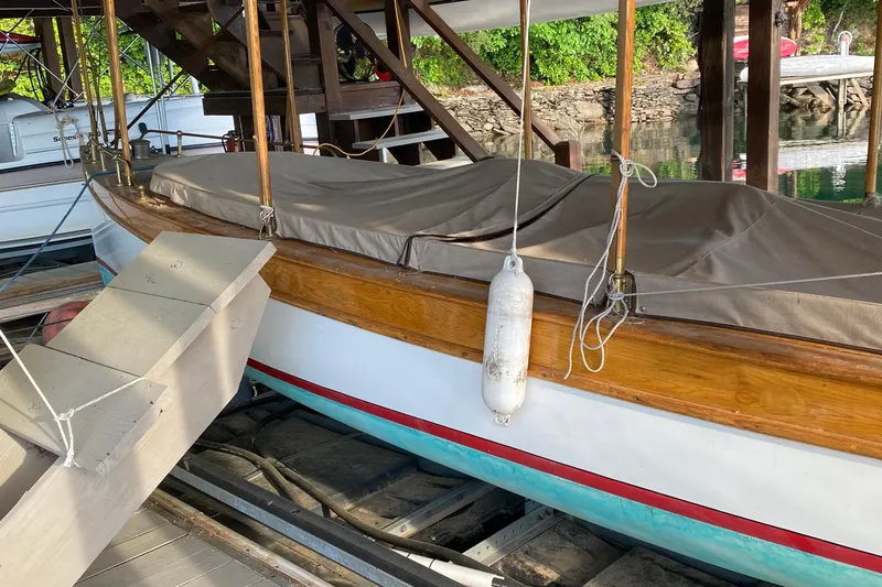 Annie Yacht Photos Pics Elco 30 Fantail Electric Launch, 1989, docked under a wooden structure with protective cover.