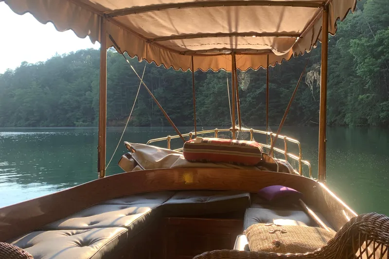 Annie Yacht Photos Pics Elco 30 Fantail Electric Launch, 1989, cruising on a serene lake surrounded by lush greenery.