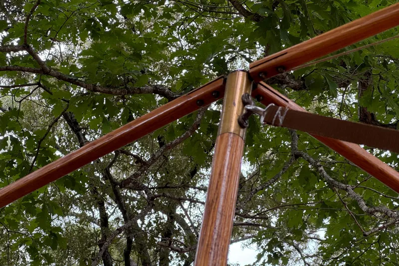 Annie Yacht Photos Pics Wooden frame structure under leafy trees, part of Elco 30 Fantail Electric Launch, 1989.