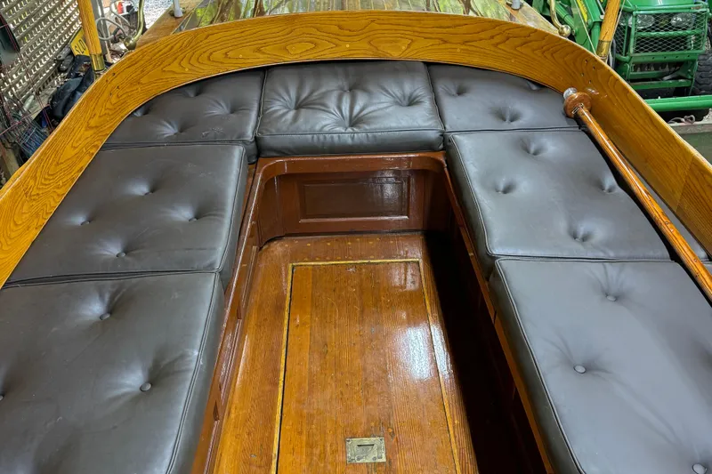 Annie Yacht Photos Pics Interior of 1989 Elco 30 Fantail Electric Launch with cushioned seating and wooden finish.