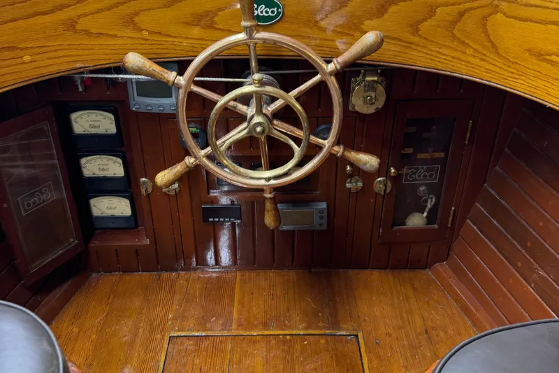 Annie Yacht Photos Pics Interior of 1989 Elco 30 Fantail Electric Launch with wooden steering wheel and vintage gauges.
