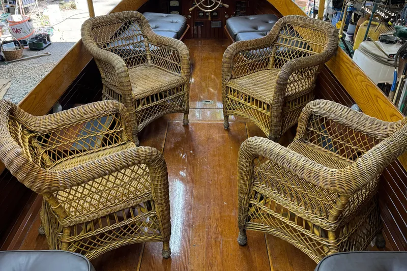 Annie Yacht Photos Pics Wicker chairs on 1989 Elco 30 Fantail Electric Launch, wooden deck interior.