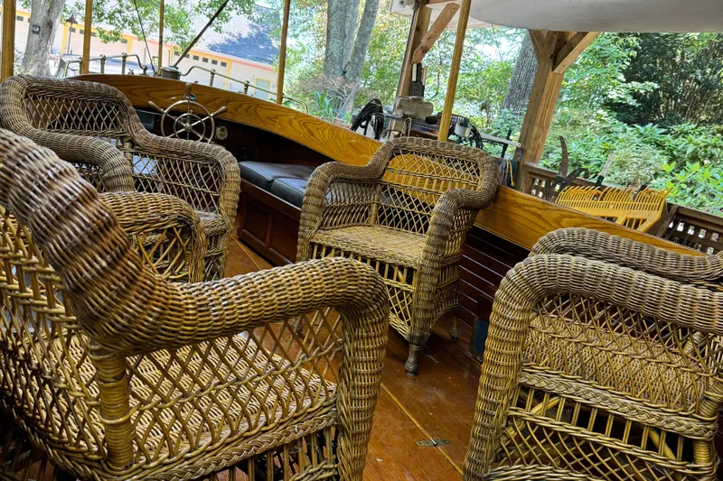 Annie Yacht Photos Pics Interior of 1989 Elco 30 Fantail Electric Launch with wicker chairs and wooden details.