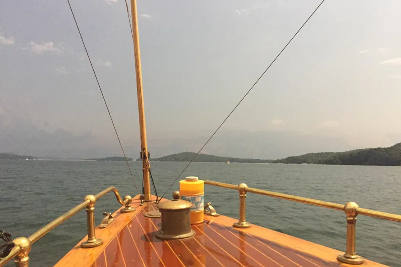 Annie Yacht Photos Pics Elco 30 Fantail Electric Launch on serene lake, 1989 model, wooden deck view.