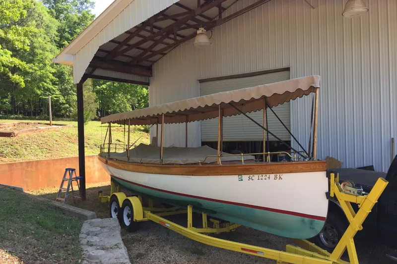 Annie Yacht Photos Pics Elco 30 Fantail Electric Launch 1989 on trailer under shelter, surrounded by greenery.