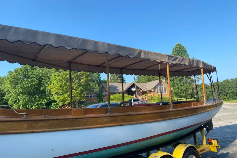 Annie Yacht Photos Pics Elco 30 Fantail Electric Launch 1989 on trailer, with canopy, in sunny outdoor setting.