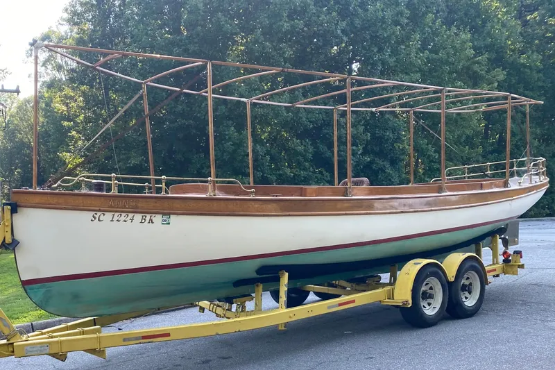 Annie Yacht Photos Pics Elco 30 Fantail Electric Launch 1989 on yellow trailer, surrounded by trees.