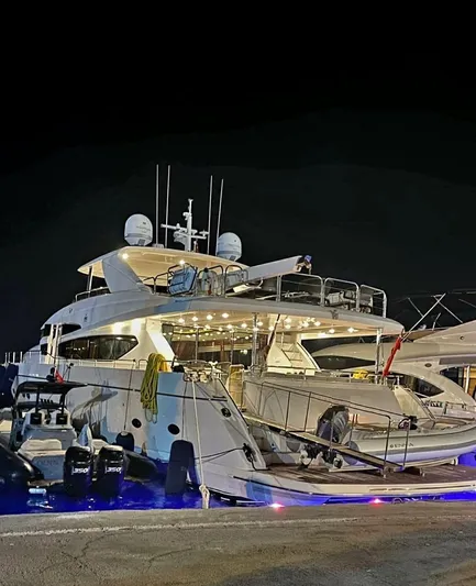  Yacht Photos Pics 2011 Princess 95 Motor Yacht docked at night with illuminated deck.
