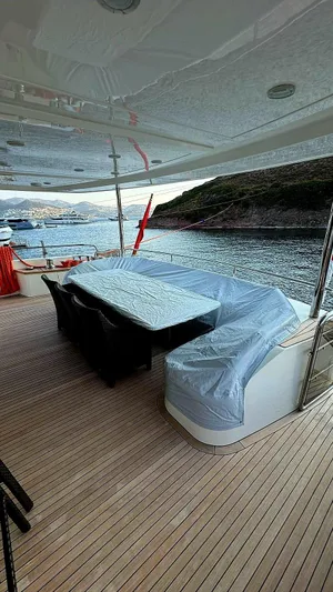  Yacht Photos Pics Luxurious 2011 Princess 95 Motor Yacht deck with seating, overlooking serene waters and scenic coastline.