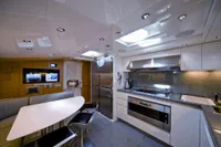 Luxurious kitchen interior of 2009 Maiora 31 yacht with modern appliances and sleek design.