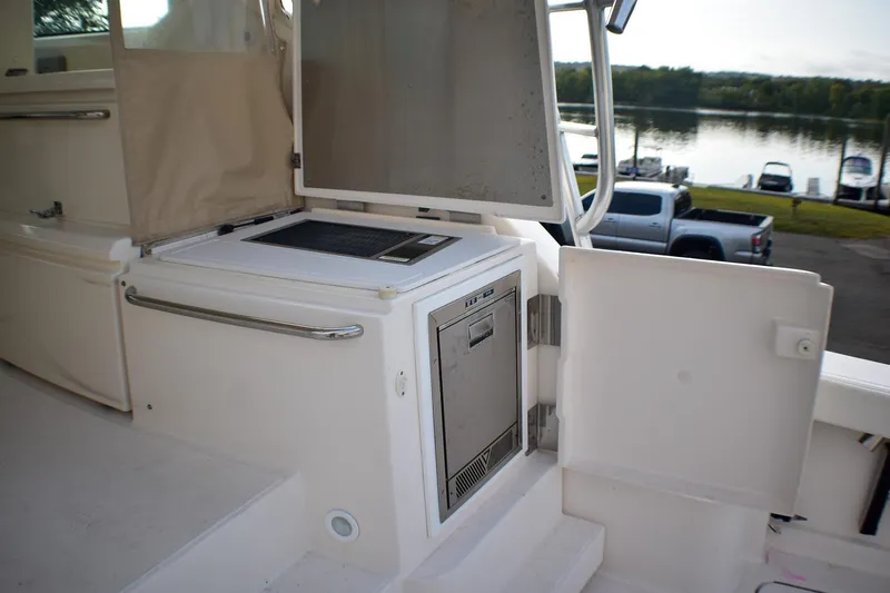 Fifth Case Yacht Photos Pics 2016 Tiara Yachts 4300 Open interior with built-in storage and appliances, dockside view.