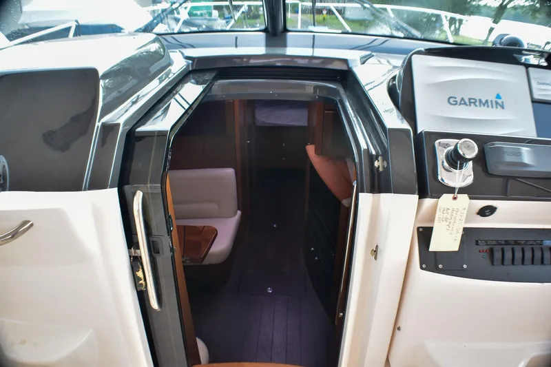 Fifth Case Yacht Photos Pics 2016 Tiara Yachts 4300 Open interior with Garmin navigation system and cozy seating area.