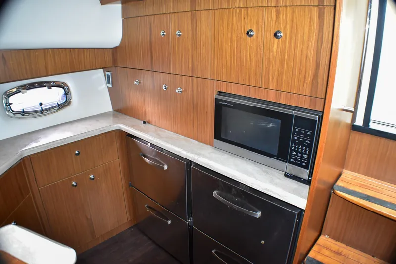 Fifth Case Yacht Photos Pics 2016 Tiara Yachts 4300 Open galley with wood cabinetry and modern appliances.