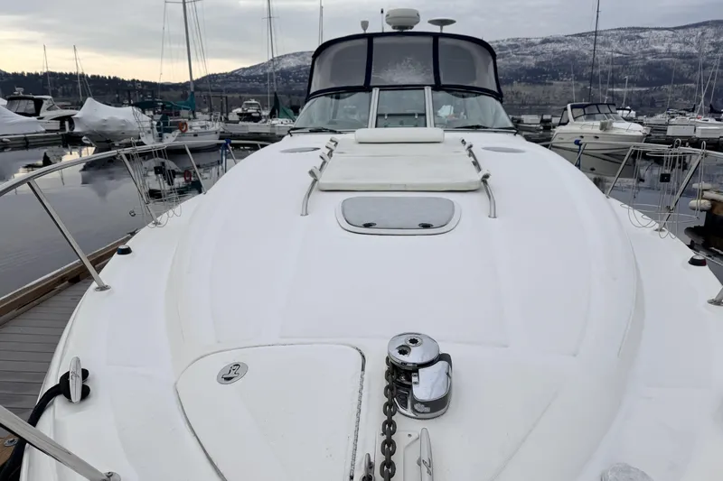  Yacht Photos Pics 2006 Sea Ray 340 Sundancer yacht docked at marina with mountainous backdrop.