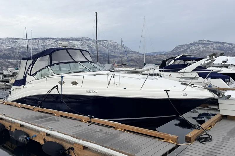  Yacht Photos Pics 2006 Sea Ray 340 Sundancer docked at a marina with scenic mountain backdrop.