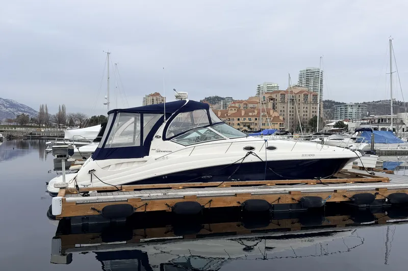  Yacht Photos Pics 2006 Sea Ray 340 Sundancer yacht docked in a marina with cityscape background.