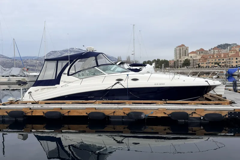  Yacht Photos Pics 2006 Sea Ray 340 Sundancer yacht docked at marina with scenic mountain backdrop.
