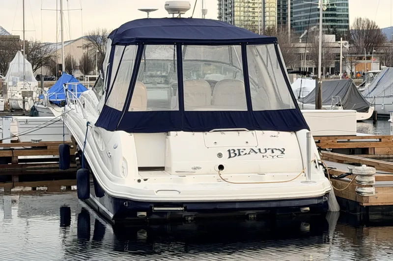  Yacht Photos Pics 2006 Sea Ray 340 Sundancer docked at marina with blue canopy.