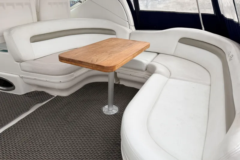  Yacht Photos Pics Luxurious seating area on a 2006 Sea Ray 340 Sundancer yacht with wooden table.