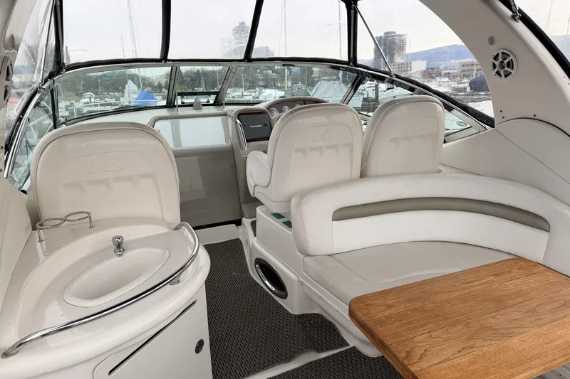  Yacht Photos Pics Interior of 2006 Sea Ray 340 Sundancer yacht with seating, sink, and wooden table.