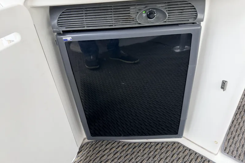  Yacht Photos Pics Compact refrigerator on 2006 Sea Ray 340 Sundancer yacht, featuring a sleek black door.