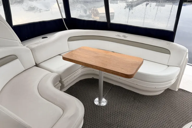  Yacht Photos Pics 2006 Sea Ray 340 Sundancer interior with white seating and wooden table.