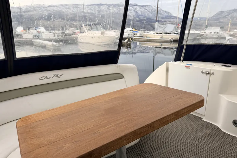  Yacht Photos Pics 2006 Sea Ray 340 Sundancer interior with wooden table and marina view.
