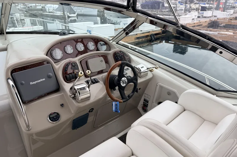  Yacht Photos Pics Helm of 2006 Sea Ray 340 Sundancer with Raymarine navigation system and luxurious seating.