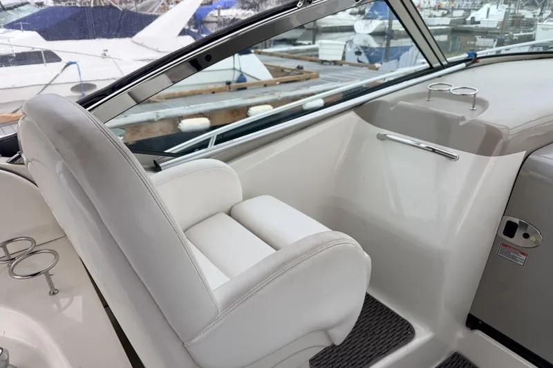  Yacht Photos Pics 2006 Sea Ray 340 Sundancer cockpit with white seating and marina view.