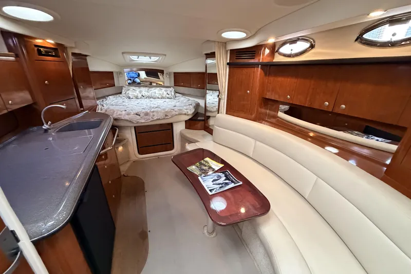  Yacht Photos Pics Interior of 2006 Sea Ray 340 Sundancer yacht with kitchen, seating, and bed.