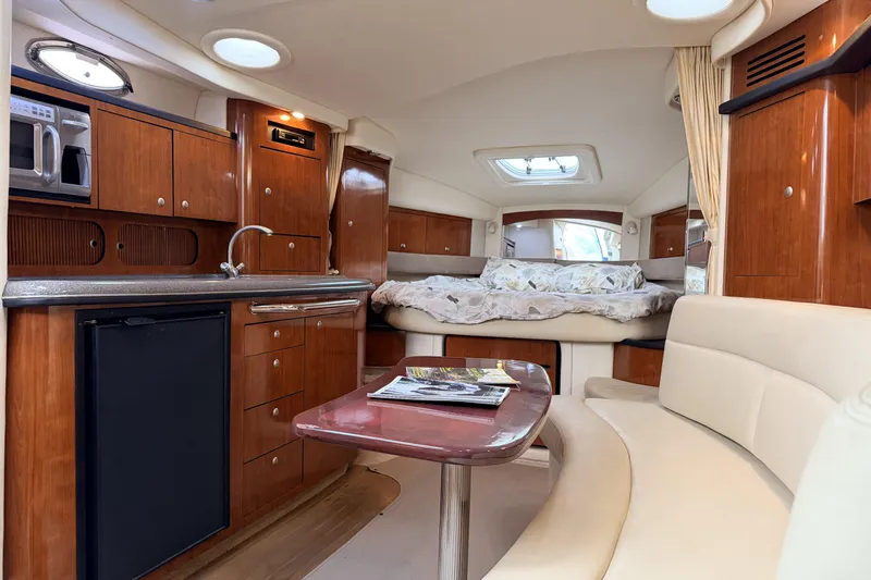  Yacht Photos Pics Luxurious interior of 2006 Sea Ray 340 Sundancer yacht with kitchenette and cozy seating area.
