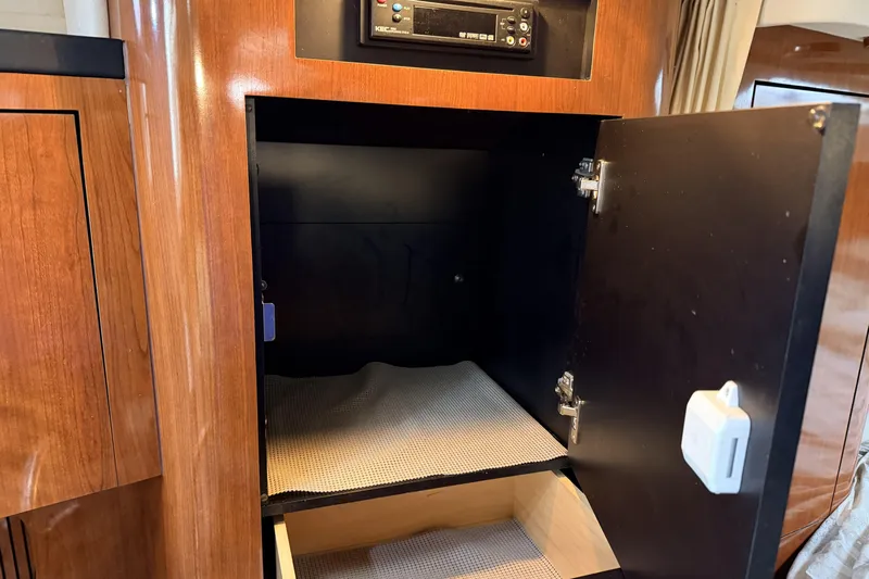  Yacht Photos Pics Open cabinet inside 2006 Sea Ray 340 Sundancer boat, featuring wood finish and storage space.