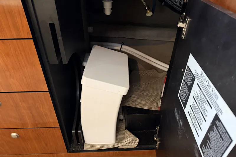  Yacht Photos Pics 2006 Sea Ray 340 Sundancer interior storage compartment with plumbing and equipment.