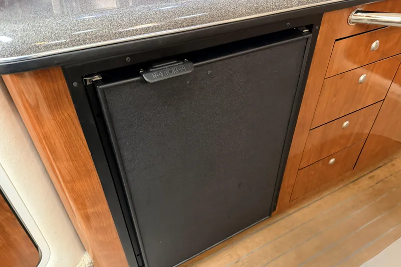  Yacht Photos Pics 2006 Sea Ray 340 Sundancer interior with wood cabinetry and built-in refrigerator.