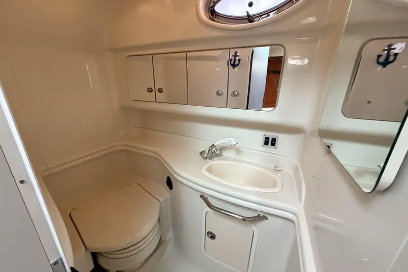  Yacht Photos Pics 2006 Sea Ray 340 Sundancer bathroom with sink, toilet, and storage cabinets.