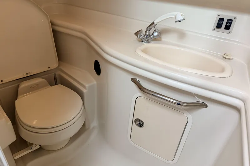  Yacht Photos Pics 2006 Sea Ray 340 Sundancer bathroom with toilet, sink, and storage compartment.