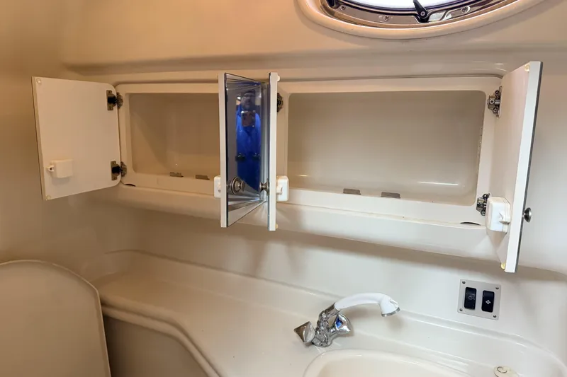  Yacht Photos Pics 2006 Sea Ray 340 Sundancer bathroom with open cabinets and sink.