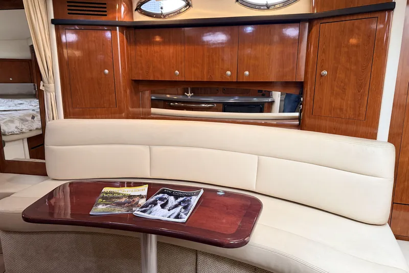  Yacht Photos Pics Interior of 2006 Sea Ray 340 Sundancer with wooden cabinets and cream seating.