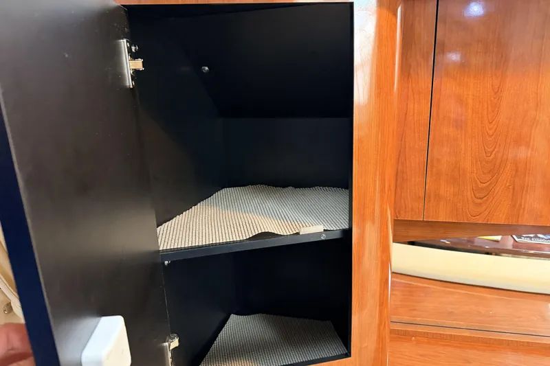  Yacht Photos Pics Open cabinet with shelves inside a 2006 Sea Ray 340 Sundancer boat.