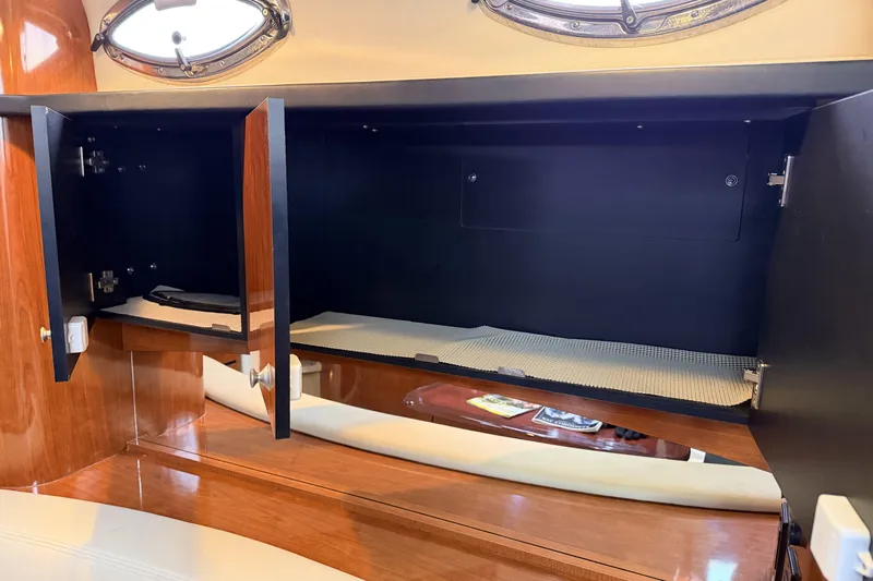  Yacht Photos Pics Open cabinet inside 2006 Sea Ray 340 Sundancer yacht, showcasing storage space.