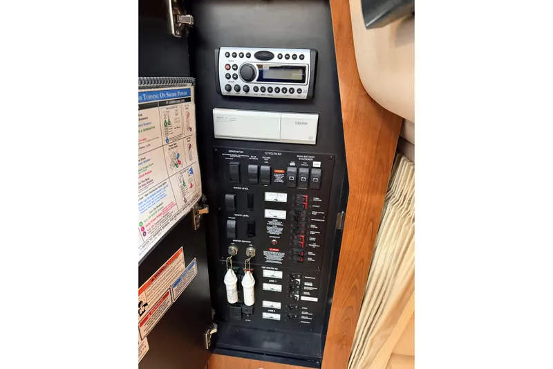  Yacht Photos Pics Electrical control panel inside 2006 Sea Ray 340 Sundancer boat, featuring switches and stereo system.